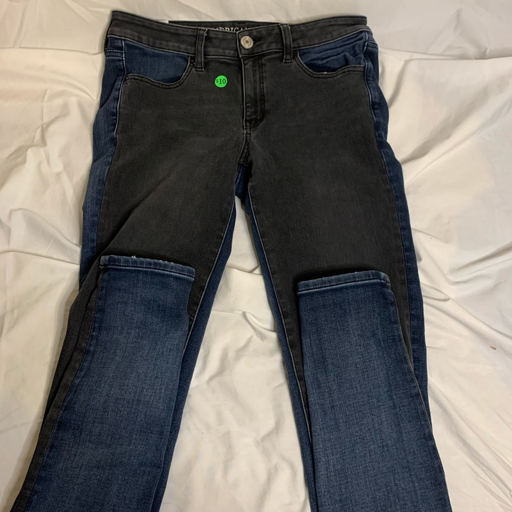 blue and black thrifted jeans